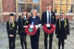Mary Robinson pictured holding a wreath with pupils of Stockport Grammar